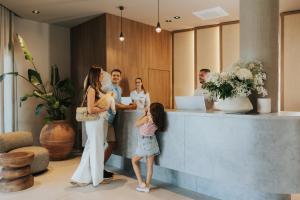 a group of people standing around a reception desk at Molum Hotel & Residences in Sveti Filip i Jakov +155 photos