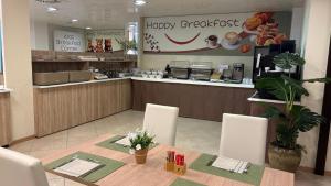 a restaurant with a table and chairs and a counter at Kairos Garda Hotel in Castelnuovo del Garda
