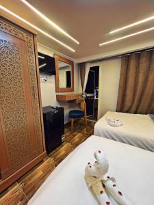 a hotel room with two birds sitting on a bed at GRAND MuseuM HoteL in Cairo