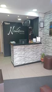 a restaurant with a counter with a sign on it at Hotel Naisca 47 in Pasto