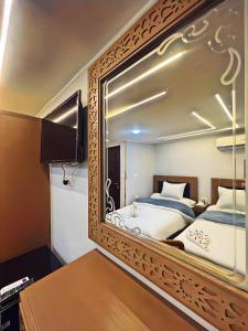 a bedroom with a mirror with a bed in it at GRAND MuseuM HoteL in Cairo