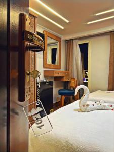 a hotel room with a bed with a swan on it at GRAND MuseuM HoteL in Cairo