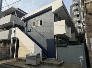 a house with a staircase leading up to a building at Court Ada -1min to Araiyakushi-mae Station, 9min train to Shinjuku- 新井薬師前駅徒歩50秒 in Tokyo