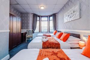 a hotel room with three beds and a desk at The Sonora Park Contactless Hotel by BET stays in Blackpool