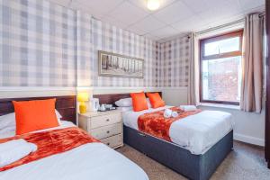 a bedroom with two beds and a window at The Sonora Park Contactless Hotel by BET stays in Blackpool +183 photos