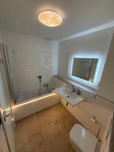 a bathroom with a tub and a sink and a toilet at Luitpold Hotel in Nuremberg +33 photos
