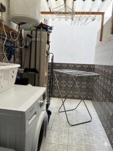 a kitchen with a counter and a table in a room at Casa Sempere in Elche +14 photos