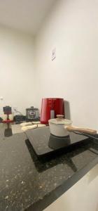 a kitchen counter with a red appliance on a table at Sou mais Icarai in Niterói