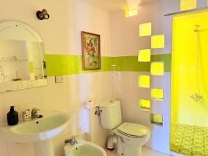 a bathroom with a white toilet and a sink at Casa Olea Vista in Chefchaouen +20 photos