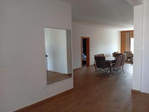 a dining room with a mirror and a table at T&S Guest House in Praia +10 photos