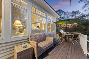 a porch with a table and chairs and an umbrella at MH3012: 3012 Marsh Haven in Seabrook Island