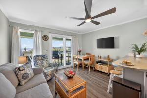 a living room with a couch and a table at SC309A: 309A Sea Cabin in Isle of Palms