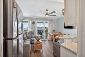 a kitchen and a living room with a refrigerator at SC309A: 309A Sea Cabin in Isle of Palms