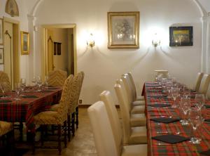 a dining room with long tables and chairs with wine glasses at Bresbot B&B in Bressana Bottarone +79 photos