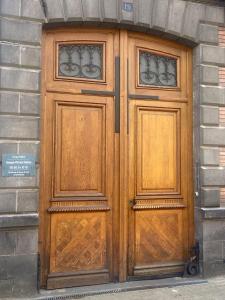 a pair of wooden doors on a building at Sweety Room in Chamalières