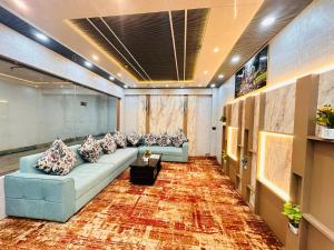 a living room with couches and a rug at Hotel Manjit Banquet in Fālākāta