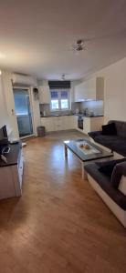 a large living room with a couch and a table at Apartman Omazić in Livno +2 photos
