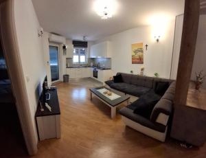 a living room with a couch and a table at Apartman Omazić in Livno