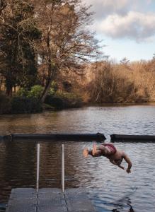 a man is swimming in a body of water at Crafted at Powdermills in Battle