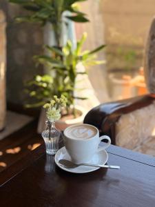 a cup of coffee on a table with a spoon at 宿杏 Yado Ann in Kofu +21 photos
