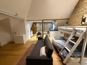 a living room with a bunk bed and a couch at 3 x Studios Golden Manor in Hanwell