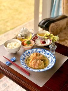 a table with a plate of food on a table with chopsticks at 宿杏 Yado Ann in Kofu