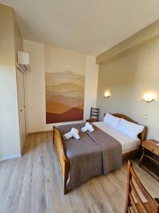 a bedroom with a large bed with towels on it at HOTEL LE FLOREAL in Le Soler