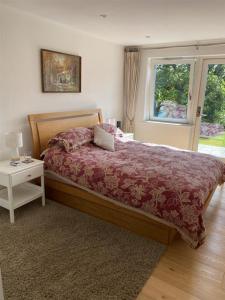 a bedroom with a bed and a table and a window at Timbers in Truro