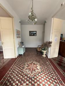 a hallway with two white doors and a tile floor at HOTEL LE FLOREAL in Le Soler