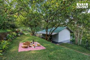 a picnic table on the grass in a yard at StayVista at Aradhya Villa with Infinity Pool, Lawn in Wayanad
