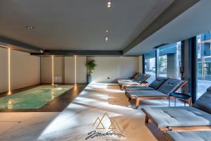 a pool in the middle of a room with couches at Apartmani Aurora Zlatibor in Zlatibor