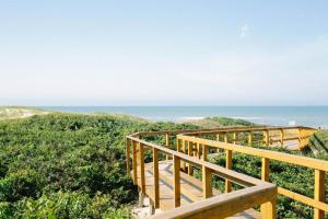 a wooden staircase leading down to the beach at Pousada Do Capitão in Florianópolis