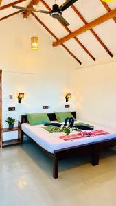 a bedroom with a large bed in a room at Surf Wave Hotel in Arugam Bay