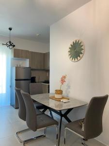 a dining room table and chairs in a kitchen at Anastasia Karystos in Karistos