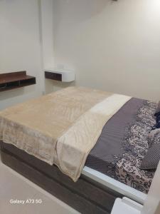 a bed in a white room with a bedvisor at The Pinnacle Retreat , Jaitala in Nagpur