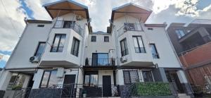 a large white building with balconies on it at Cozy Corner in Tbilisi City