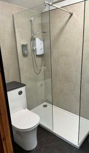 a bathroom with a shower and a toilet at 1 Manse Lane in Portree +7 photos