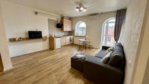 a living room with a couch and a kitchen at Апартаменти над каньйоном in Kamianets-Podilskyi