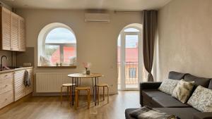 a living room with a couch and a table at Апартаменти над каньйоном in Kamianets-Podilskyi