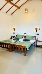 a bedroom with a large bed in a room at Surf Wave Hotel in Arugam Bay +48 photos