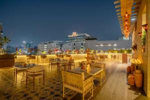 a restaurant with tables and chairs on a rooftop at Arnna-Nesco Goregaon in Mumbai +66 photos