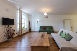 a living room with a couch and a table at Bianca Studio in Krakow