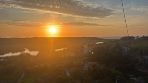 a sunset over a body of water with the sun setting at Kitinet in Marataizes +6 photos