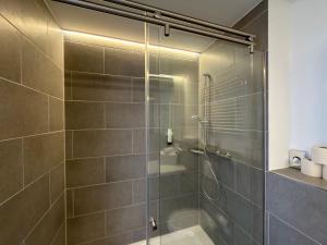 a bathroom with a shower with a glass door at Printhouse in Münster +67 photos