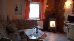 a living room with a couch and a fire place at Spreewaldhäuser Golinski mit Kamin am Neuendorfer See in Alt Schadow