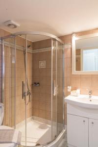 a bathroom with a shower and a sink at Gorgones, sea-front, great view in Kardamyli +73 photos