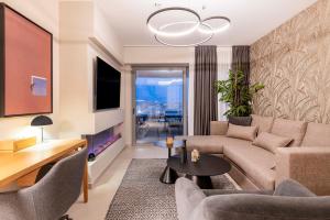 a living room with a couch and a table at The HostMaster 910 Loft in Piraeus