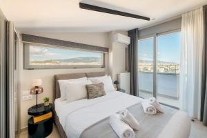 a bedroom with a large bed and a large window at The HostMaster 910 Loft in Piraeus +39 photos