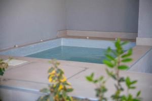 a swimming pool in a room with blue water at The HostMaster 910 Loft in Piraeus