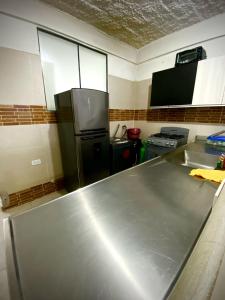 a kitchen with a large stainless steel counter top at Palmeras 2 in Manizales